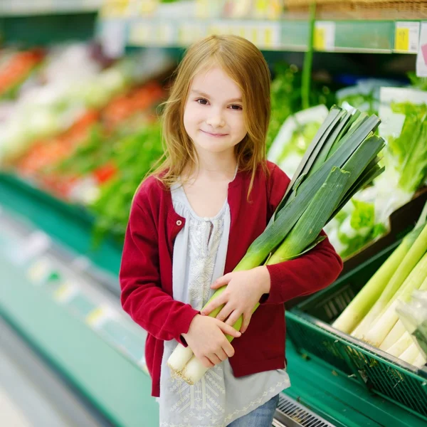 Little girl choosing leek — Stock Photo, Image