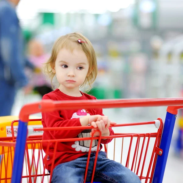 Toddler girl in shopping cart — Stock Photo, Image