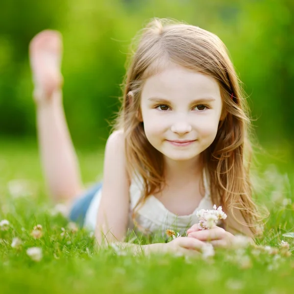 Little girl laying on grass — Stock Photo, Image