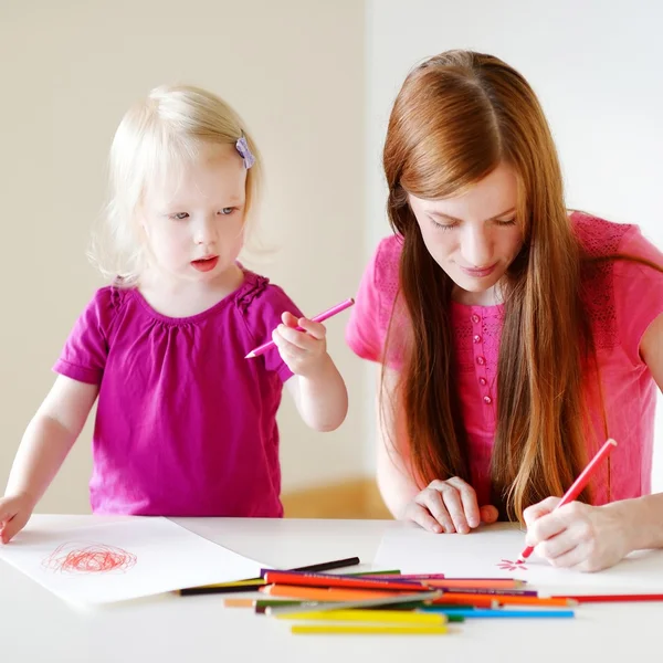 Mother and little daughter drawing Stock Picture