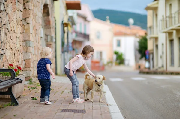 Cute little sisters and a dog — Stock Photo, Image