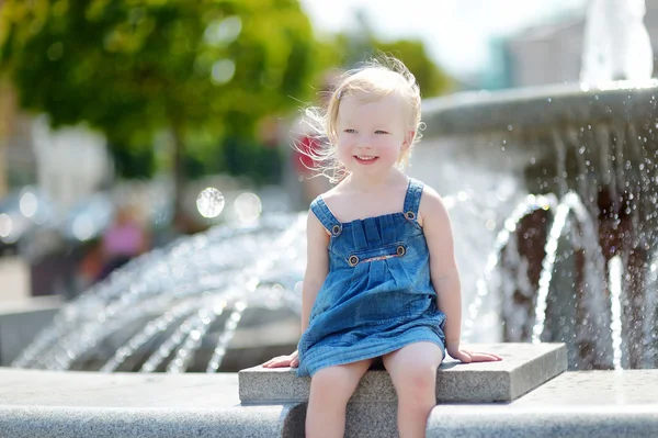 Dziewczyna bawi sie z miasta fontanna — Zdjęcie stockowe
