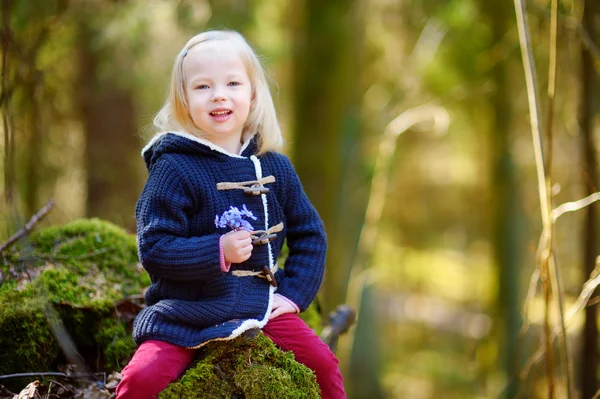 Girl picking the first flowers — Stock Photo, Image