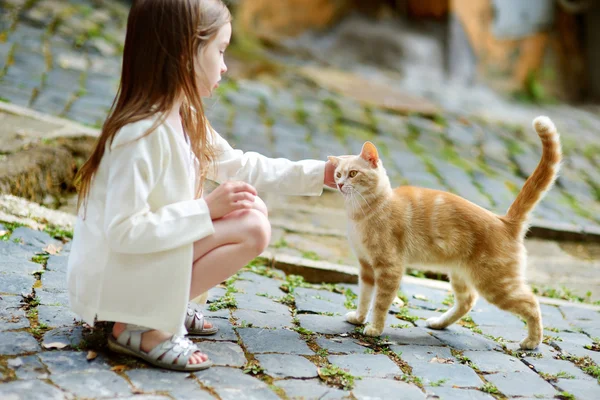Очаровательная маленькая девочка и кошка — стоковое фото