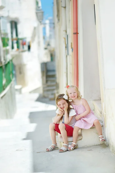 adorable little sisters laughing