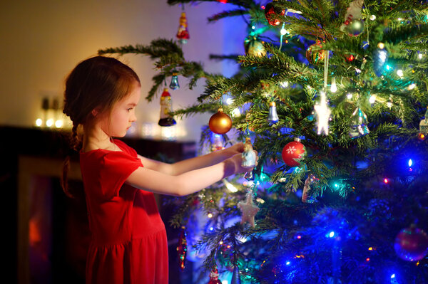 girl decorating a Christmas tree