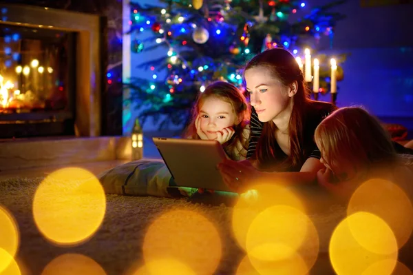 Mother and daughters using  tablet — Stock Photo, Image