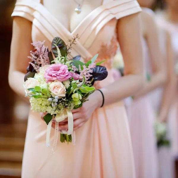 Row of bridesmaids with bouquets — Stock Photo, Image