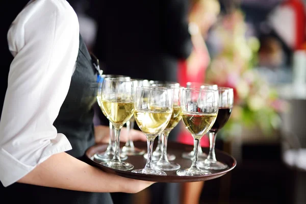 Waitress with dish of champagne — Stock Photo, Image