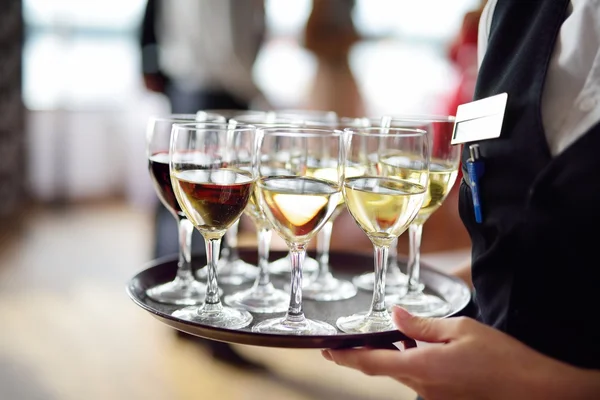 Waitress with dish of champagne — Stock Photo, Image