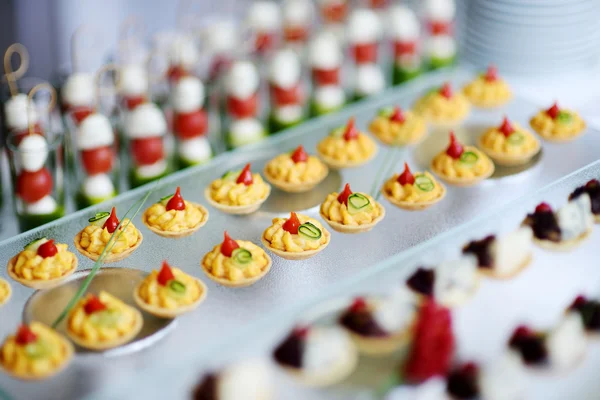 Plates with assorted snacks — Stock Photo, Image