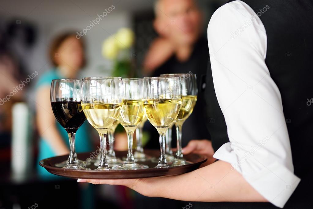 Waitress with dish of champagne
