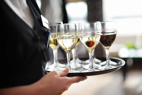 Waitress with dish of champagne — Stock Photo, Image