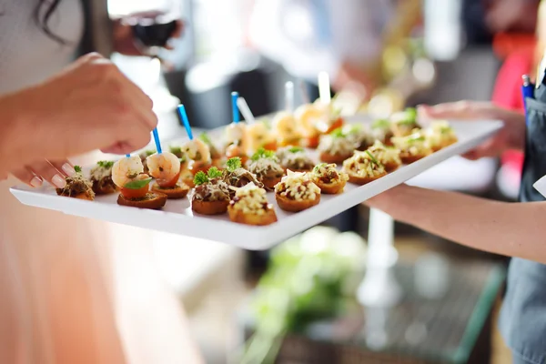 Waiter carrying plates with meat dish — Stock Photo, Image