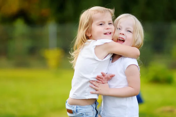 Little sisters laughing and hugging — Stock Photo, Image