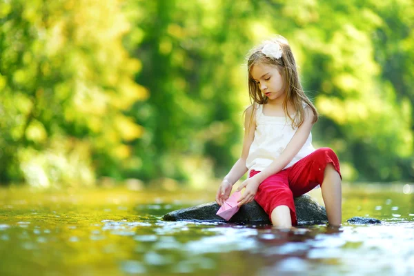 Girl playing with paper boat — Stock Photo, Image