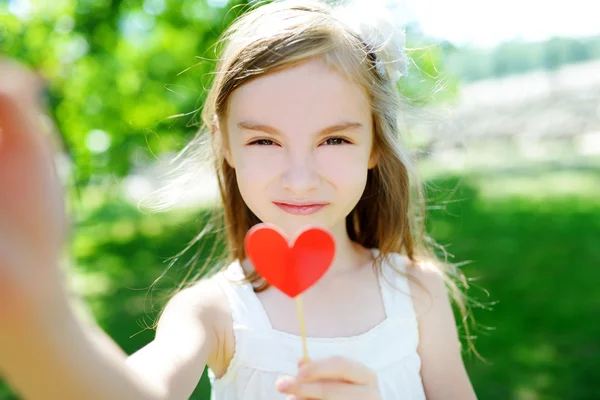 Mädchen mit Papierherz auf einem Stock — Stockfoto