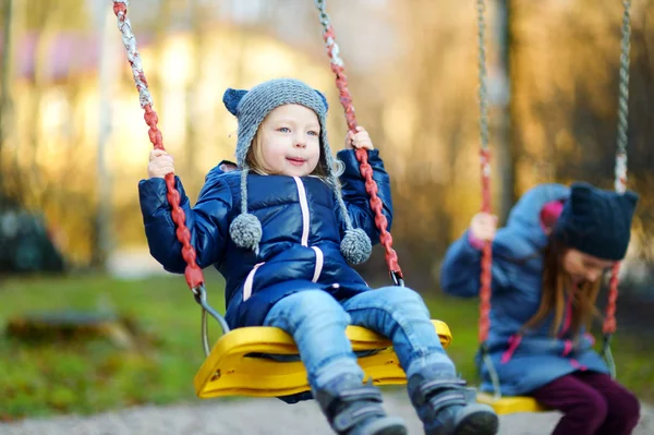 Girls having fun on a swing — Stock Photo, Image