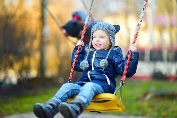 Girl having fun on a swing — Stock Photo, Image