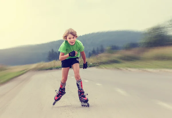 Funny Boy rollerblading on the road . — Stock Photo, Image