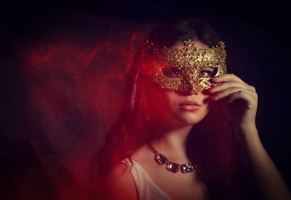 Beautiful young woman with a masquerade mask. Stock mixed light. — Stock Photo, Image
