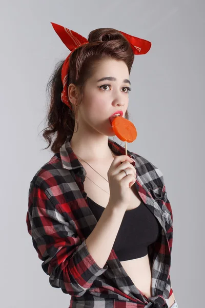 Happy girl licking a lollipop . — Stock Photo, Image