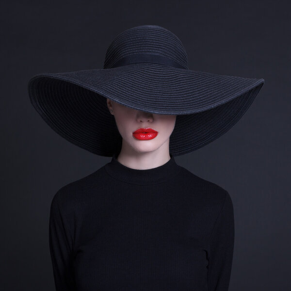 Luxury woman in a large black hat