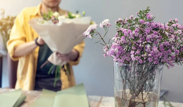 Florist decorates a bouquet of flowers. Arrangement of flowers. The concept of small business.