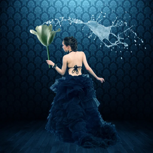 Woman in dress   with large flower — Stock Photo, Image