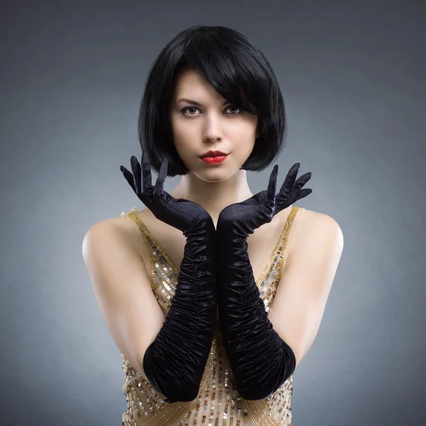 Woman with stylish hairstyle and black gloves — Stock Photo, Image