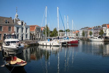 Sailboats at dock in city