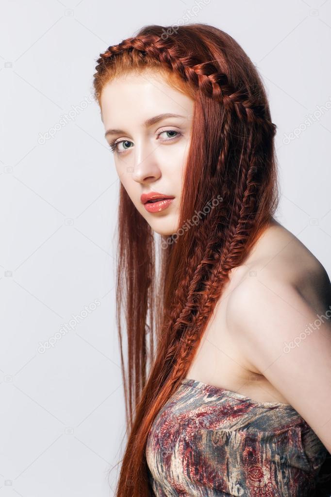 Young woman with ginger braids hairdo on white background Stock Photo