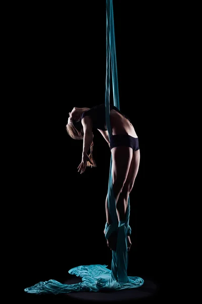 Young woman gymnast with blue gymnastic ribbon