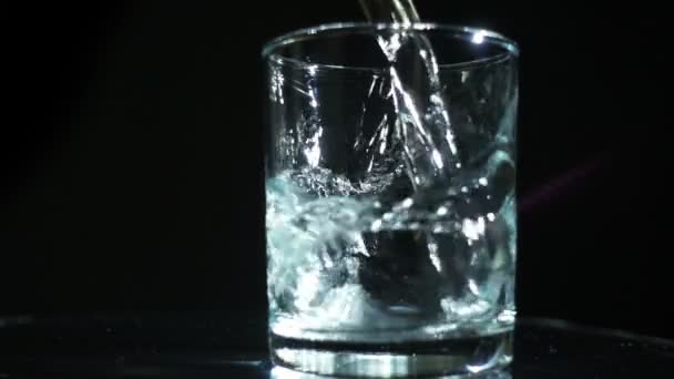 Pouring water in glass slow motion — Stock Video