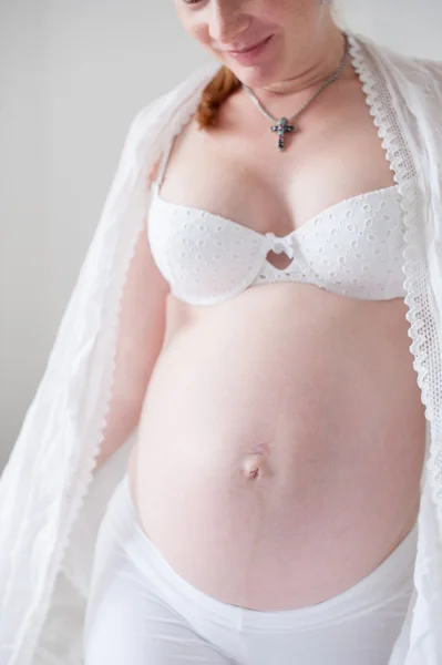 Stomach of pregnant redhead woman — Stock Photo, Image