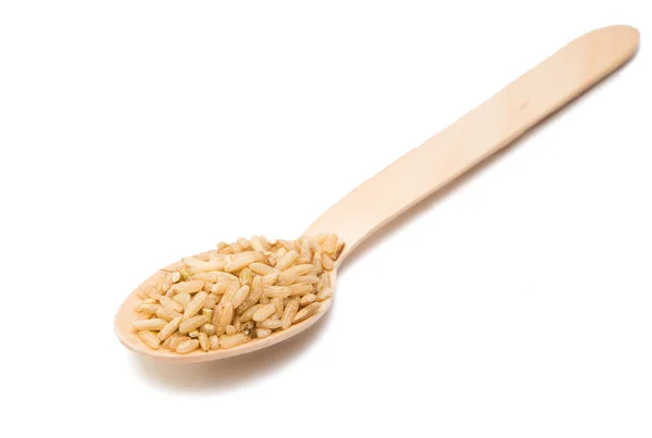 Rice in a wooden spoon isolated — Stock Photo, Image