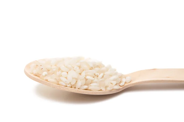 Rice in a wooden spoon isolated — Stock Photo, Image
