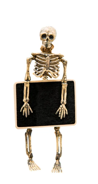 Ett skelett med en skylt — Stockfoto