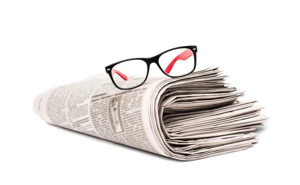 Newspaper with glasses closeup — Stock Photo, Image