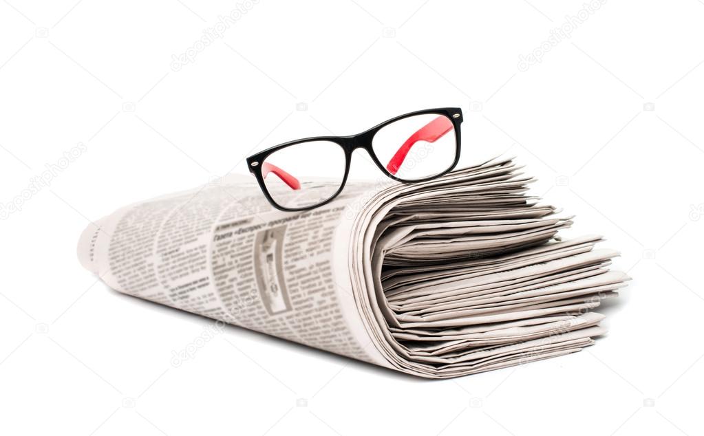 newspaper with glasses closeup