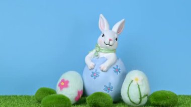 Yeşil çimlerin üzerinde yumurtaları olan tavşanların güzel bir Paskalya süslemesinin videosu..
