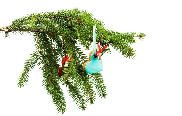 Gingerbread ornaments hanging on fir branch — Stock Photo, Image