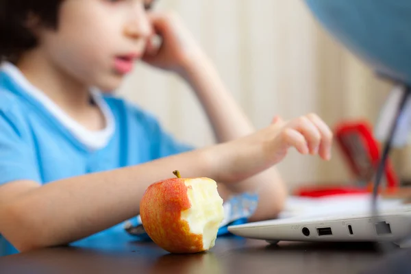 Bitten apple and a boy with computer