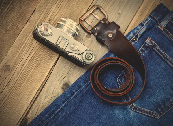 rangefinder camera, vintage leather belt and blue jeans