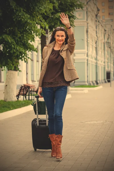 pretty adult woman traveler with suitcase