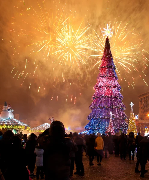 Christmas tree and fireworks — Stock Photo, Image