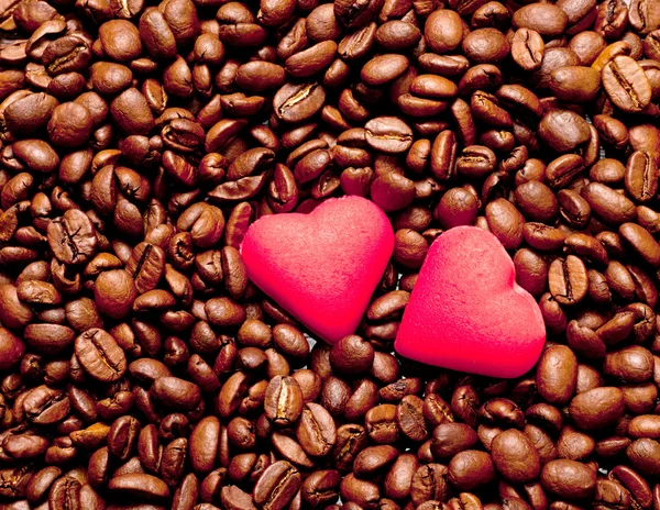 Two red hearts on coffee beans — Stock Photo, Image