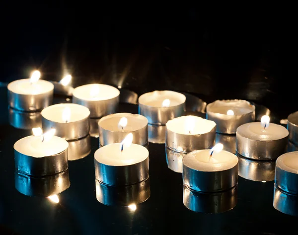 Burning candles on a black background — Stock Photo, Image