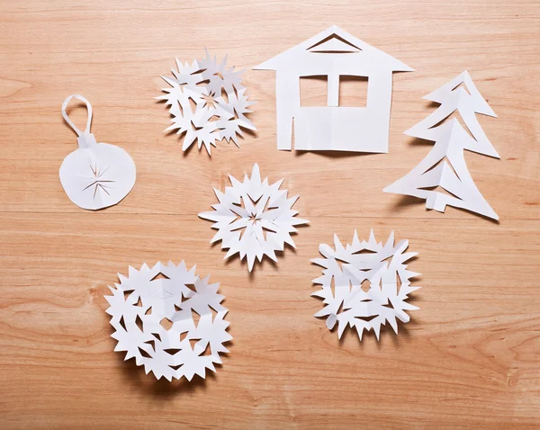 Paper snowflakes and other decoration on table — Stock Photo, Image