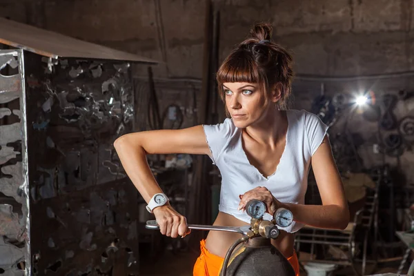 Mechanic woman in sexy uniform is working with the spanner Royalty Free Stock Images